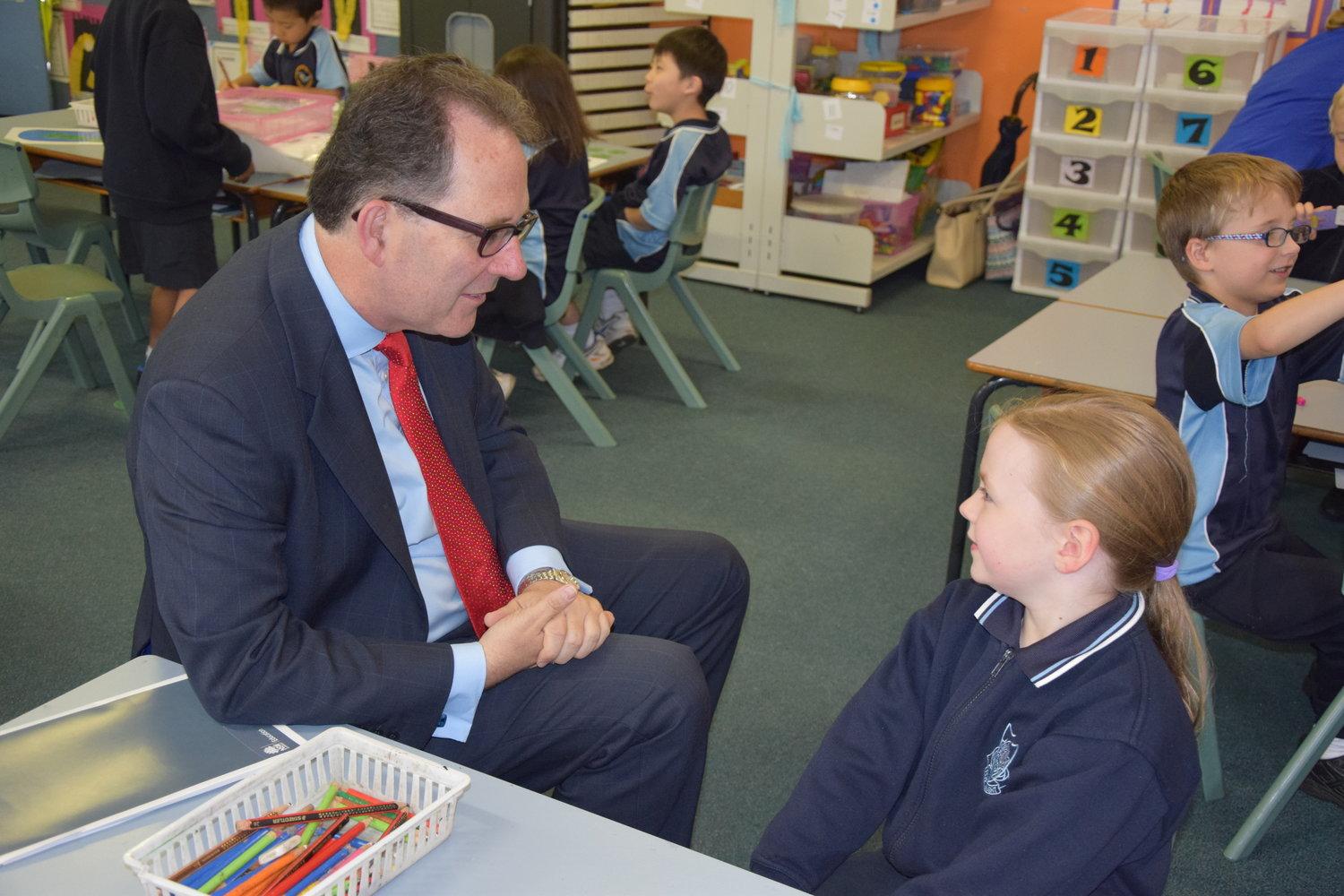 Alister speaking to a school student 