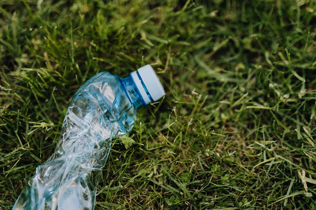 Discarded plastic water bottle on grass